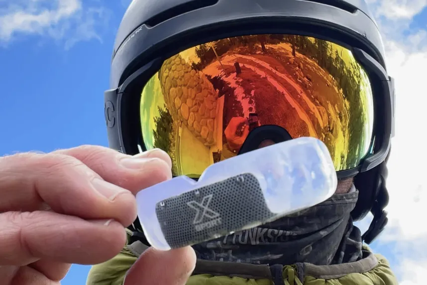 Snowboarder holding a mouth guard